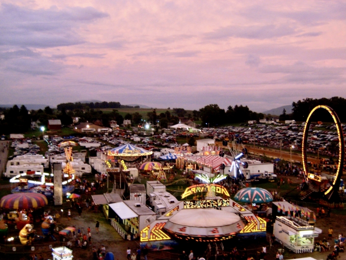Carnival landscape with ferris wheel and booths