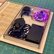 Detailed view of lit-up microcontroller with pink lights